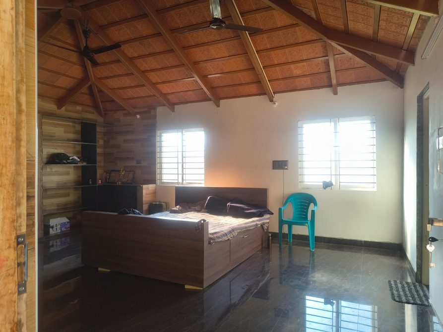 Kerala villa bedroom with heritage wooden ceiling
