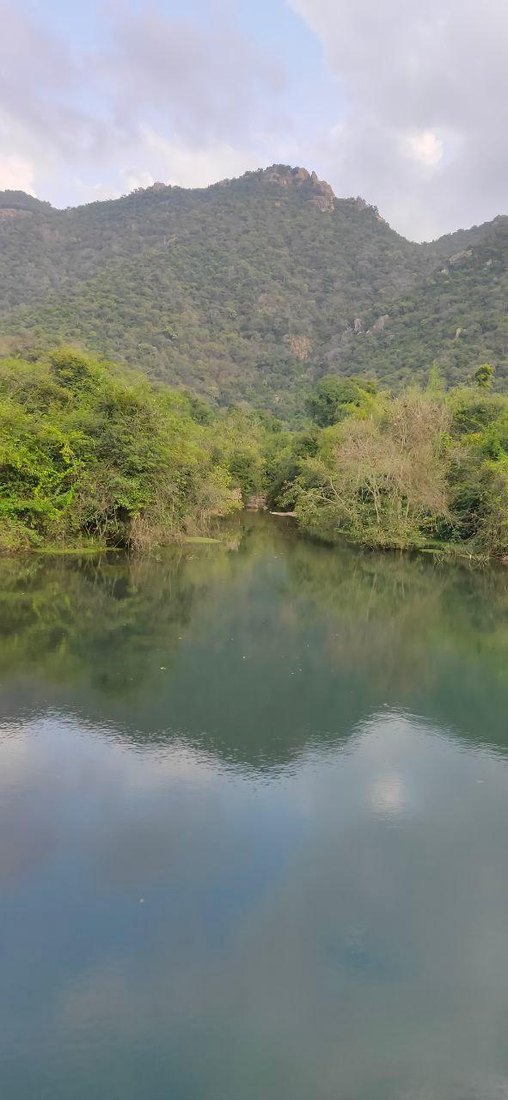 Stunning mountain lake reflection — the source of natural water that flows to Marutham Villa
